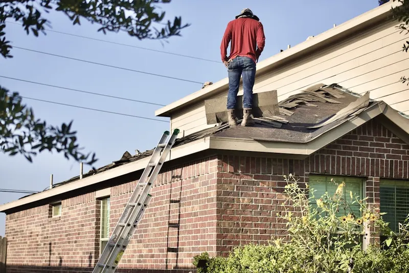 Professional roofer working on a residential roof in Village of Pickering Run
